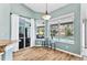 Bright breakfast nook with views of the pool area, featuring white curtains and a table with stools at 633 Lakehaven Cir, Orlando, FL 32828