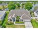 Charming single Gathering home featuring manicured landscaping, a blue door, and a two-car garage at 633 Lakehaven Cir, Orlando, FL 32828