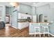 Open kitchen featuring white cabinets, granite countertops, a breakfast bar, and stainless steel appliances at 633 Lakehaven Cir, Orlando, FL 32828