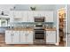 Kitchen with white cabinets, granite countertops, and stainless steel appliances, including a microwave and oven at 633 Lakehaven Cir, Orlando, FL 32828