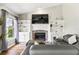 Comfortable living room featuring a brick fireplace, built-in shelves, and a large window for natural light at 633 Lakehaven Cir, Orlando, FL 32828