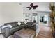 Cozy living room showcasing a large gray sectional sofa and views into other areas of the home at 633 Lakehaven Cir, Orlando, FL 32828