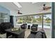 Covered patio offers stylish seating area with picturesque pool and water views at 633 Lakehaven Cir, Orlando, FL 32828