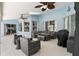 Covered patio boasts an outdoor living space with comfortable seating, ceiling fans, and water views at 633 Lakehaven Cir, Orlando, FL 32828