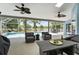 Screened-in patio with fan overlooks pool and lake at 633 Lakehaven Cir, Orlando, FL 32828