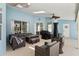 Large screened patio with a ceiling fan, wicker furniture, and light blue walls at 633 Lakehaven Cir, Orlando, FL 32828