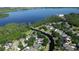 Aerial view of a waterfront neighborhood with lush greenery and clear blue water at 6350 Sedona Leaf Ct, Windermere, FL 34786