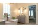 Bathroom featuring a soaking tub under a window for natural light and an elegant vanity at 6350 Sedona Leaf Ct, Windermere, FL 34786