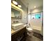 Well-lit bathroom with white subway tiles, sleek fixtures, and a modern floating sink and vanity at 6350 Sedona Leaf Ct, Windermere, FL 34786