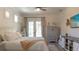 Bright bedroom boasts neutral tones, french doors to the outside, and an entertainment center at 6350 Sedona Leaf Ct, Windermere, FL 34786
