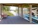 Covered boat dock with boat lift, offering convenient access to the water and storage for watercraft at 6350 Sedona Leaf Ct, Windermere, FL 34786