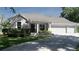 Charming home with a well-manicured lawn, flower beds, covered porch, and a two-car garage at 6350 Sedona Leaf Ct, Windermere, FL 34786