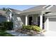 Charming front porch featuring a brick flower bed, white columns, and outdoor seating at 6350 Sedona Leaf Ct, Windermere, FL 34786