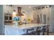 Modern kitchen with stainless steel appliances, quartz countertops, and bar stool seating at 6350 Sedona Leaf Ct, Windermere, FL 34786