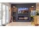 Cozy living area with a fireplace, wall-mounted TV, and French doors with plenty of natural light at 6350 Sedona Leaf Ct, Windermere, FL 34786
