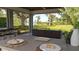 Covered outdoor seating area overlooking lush greenery and waterfront views, ideal for enjoying the serene surroundings at 6350 Sedona Leaf Ct, Windermere, FL 34786
