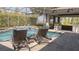 Inviting screened-in pool area with lounge chairs and covered outdoor seating, perfect for relaxation and entertaining at 6350 Sedona Leaf Ct, Windermere, FL 34786