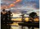 Picturesque sunset water view with silhouetted trees, creating a serene and calming residential backdrop at 6350 Sedona Leaf Ct, Windermere, FL 34786