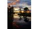 Beautiful twilight water view reflecting a vibrant sky and surrounding trees, enhancing the property's appeal at 6350 Sedona Leaf Ct, Windermere, FL 34786