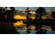 Scenic water view reflecting a stunning sunset, framed by lush trees and providing a tranquil atmosphere at 6350 Sedona Leaf Ct, Windermere, FL 34786
