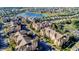 Aerial view of the community showing the buildings, parking, landscaping, and nearby lake at 7650 Comrow St # 403, Kissimmee, FL 34747