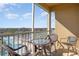 View from the screened balcony with seating overlooking a pool and green space at 7650 Comrow St # 403, Kissimmee, FL 34747