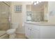 Clean bathroom with a tiled shower, vanity with mirror, and a modern toilet and tiled floor at 7650 Comrow St # 403, Kissimmee, FL 34747