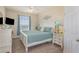 Comfortable bedroom featuring a white bed frame, large windows with curtains, and soft carpet flooring at 7650 Comrow St # 403, Kissimmee, FL 34747