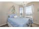 Cozy bedroom with elegant chandelier, canopy bed, large windows and decorative accents at 7650 Comrow St # 403, Kissimmee, FL 34747