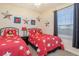 Whimsical bedroom featuring red and white bed sets, themed decor and a playful design at 7650 Comrow St # 403, Kissimmee, FL 34747