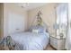 Charming bedroom with a canopy bed, chandelier, white curtains, and mirrored night stand at 7650 Comrow St # 403, Kissimmee, FL 34747