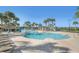 Large community pool with lounge chairs, tropical landscaping, and a splash pad, perfect for relaxation at 7650 Comrow St # 403, Kissimmee, FL 34747