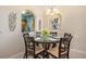 Charming dining area with seating for six, arched doorway, and delightful kitchen view at 7650 Comrow St # 403, Kissimmee, FL 34747