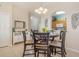 Cozy dining area featuring a round table with seating for four, leading to the kitchen area at 7650 Comrow St # 403, Kissimmee, FL 34747