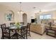 Dining area with a glass table, seating for six, and natural light, seamlessly connected to the living room at 7650 Comrow St # 403, Kissimmee, FL 34747