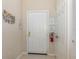 Inviting entryway featuring a white front door, neutral walls, and tiled floor and welcome sign at 7650 Comrow St # 403, Kissimmee, FL 34747
