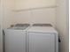 Laundry area with front load washer and dryer and wire rack at 7650 Comrow St # 403, Kissimmee, FL 34747