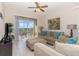Comfortable living room with sliding glass doors to balcony that provides great outdoor view and seating at 7650 Comrow St # 403, Kissimmee, FL 34747