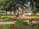 Community playground and picnic area amidst lush trees, perfect for Gathering fun and outdoor gatherings at 7650 Comrow St # 403, Kissimmee, FL 34747