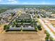 Aerial view of the neighborhood with townhomes surrounded by green trees at 774 Chelsea Dr, Davenport, FL 33897