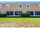 Green backyard view of the townhomes with well manicured lawns, patios and window views at 774 Chelsea Dr, Davenport, FL 33897