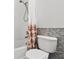 Bathroom with shower over tub, mosaic tile and modern toilet at 774 Chelsea Dr, Davenport, FL 33897
