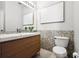 Bright bathroom featuring a floating sink, modern fixtures, and tiled wall at 774 Chelsea Dr, Davenport, FL 33897