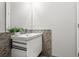 Contemporary bathroom featuring a modern vanity with mosaic tile accents and a sleek faucet at 774 Chelsea Dr, Davenport, FL 33897
