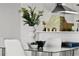 Modern dining room decor with clean lines, light colors, and bright light from the kitchen at 774 Chelsea Dr, Davenport, FL 33897