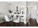 Dining Area featuring dark hardwood floors, stylish table set, and open concept design at 774 Chelsea Dr, Davenport, FL 33897
