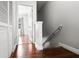 Bright hallway showcasing hardwood floors, white trim, and access to rooms with natural light at 774 Chelsea Dr, Davenport, FL 33897