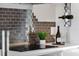 Kitchen with stainless steel appliances, stylish wine rack, and dark backsplash at 774 Chelsea Dr, Davenport, FL 33897