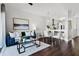 Bright living room featuring dark hardwood floors, a blue couch, and natural light at 774 Chelsea Dr, Davenport, FL 33897