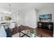 Open concept living room features dining area and access to the kitchen with hardwood floors at 774 Chelsea Dr, Davenport, FL 33897